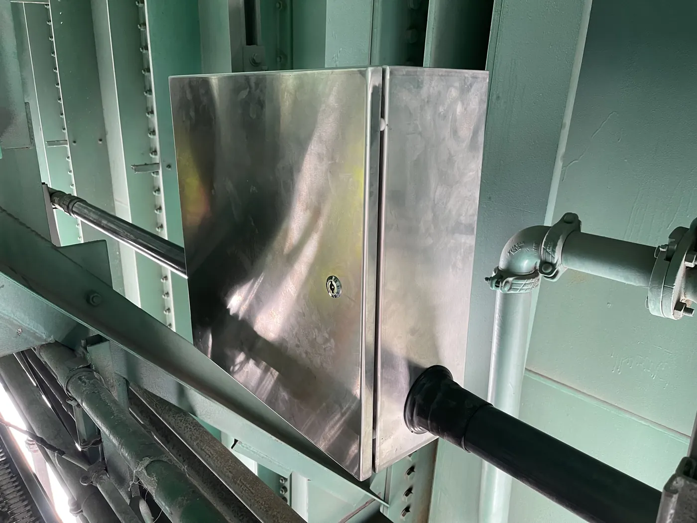 Stainless steel enclosure mounted to the bridge steel with the fiber duct entering from below
